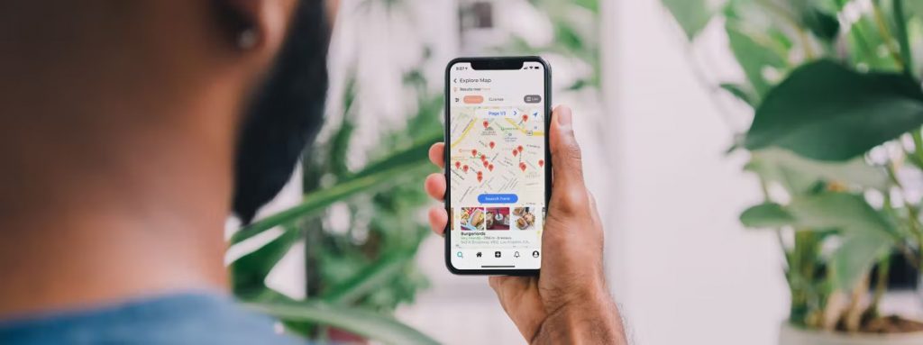 man holding a phone browsing for routes